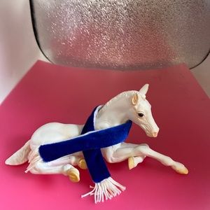 White composite horse laying down